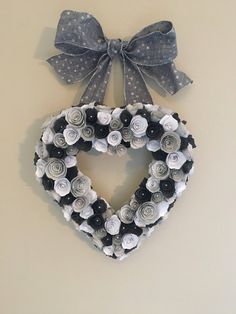 a heart shaped wreath hanging on the wall