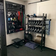 there is a rack with many items in the room and one has a barbell on it