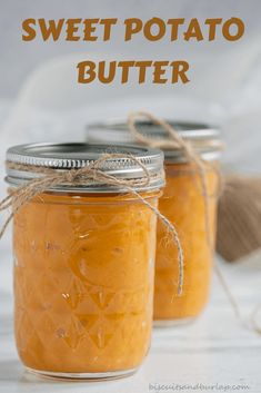 two jars filled with sweet potato butter sitting on top of a white table next to a twine of twine