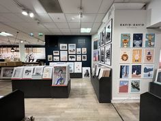 the inside of a store with pictures on the wall and photos hanging on the walls