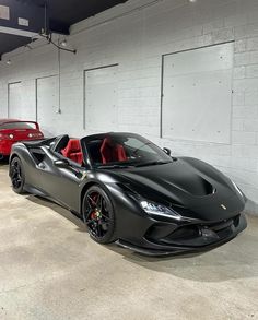 two cars parked in a garage next to each other