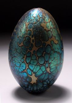 an egg with blue and gold designs on it