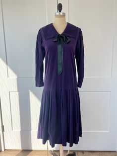 "Vintage 1980s purple corduroy Laura Ashley, dropwaist pleated midi dress with square sailor collar & bow around the neckline. In very good vintage condition, mending present on side. B: 36\" W: 36\" L: 38\" Recommended for US 4/6" Vintage Purple Dress For Fall, Purple Vintage Dress For Fall, Vintage Purple Fall Dresses, Floral Lace Maxi Dress, Sailor Dress, Striped Long Sleeve Tee, 1980s Dresses, Sailor Collar, 80s Dress