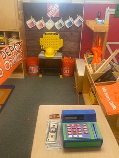 a desk with a calculator and money on it in a room filled with toys