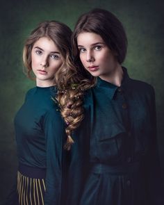 two young women with long hair are posing for the camera