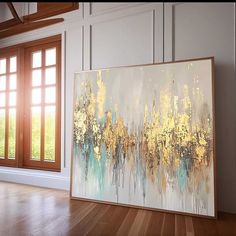 an abstract painting is displayed in front of a window with wooden floors and large windows