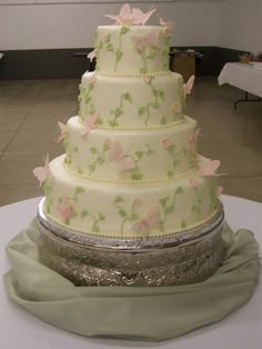 a three tiered wedding cake with pink flowers on it