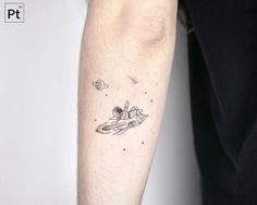 a tattoo on the arm of a person with space shuttles and planets in the background