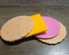 three pieces of food sitting on top of a wooden table