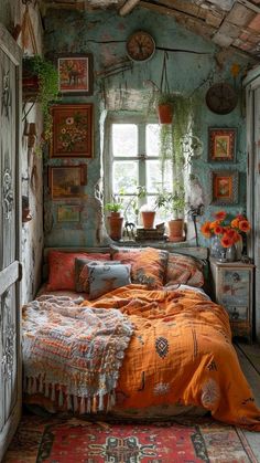 a bed sitting in a bedroom next to a window with potted plants on it