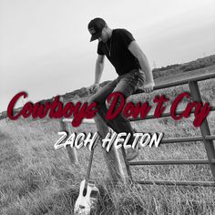 a man sitting on top of a wooden fence next to a cowgirl's don't cry sign