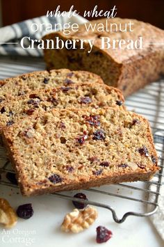 two slices of orange walnut cranberry bread on a cooling rack