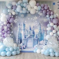 a backdrop with balloons, snowflakes and castle