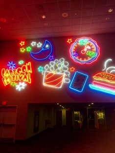 neon signs are lit up on the wall