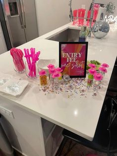 a white counter topped with lots of pink decorations