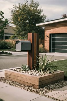 a mailbox and planter in front of a house