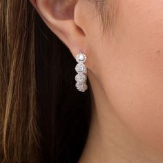 A chic look with sparkle to spare, these diamond hoop earrings are certain to be admired. Created in cool 10K white gold, each stunning hoop showcases five 1/10 ct. diamonds, each wrapped in a diamond frame. Captivating with 1-1/2 cts. t.w. of diamonds and a bright polished shine, these earrings secure with hinged backs. Halo Cubic Zirconia Diamond Hoop Earrings, Halo Cubic Zirconia Hoop Diamond Earrings, Stone Hoop Earrings, Diamond Frame, Earrings Diamond, Diamond Hoop Earrings, Diamond Earrings, Hoop Earrings, Diamonds