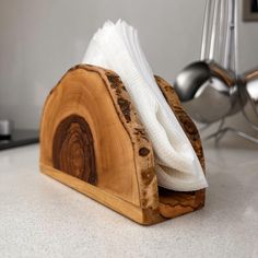 a napkin holder made out of wood on a counter