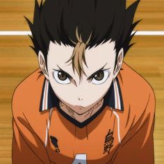 an anime character with black hair and brown eyes looks at the camera while standing in front of a basketball court