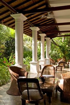 an outdoor seating area with wicker chairs and tables