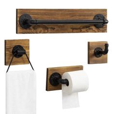 three toilet paper holders and two rolls of toilet paper hanging on the wall next to each other