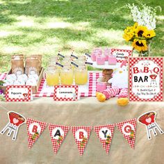 a baby shower is set up on a table with red and white gingham