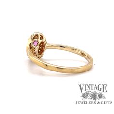 14 karat yellow gold oval pink sapphire and diamond halo ring, side view