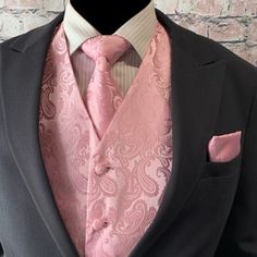 a mannequin wearing a suit and tie with a pink paisley print on it