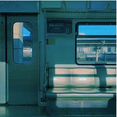 an empty subway car with its doors open and the sun shining through it's windows