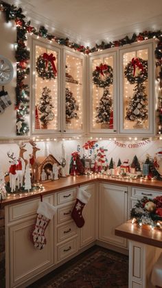 a kitchen decorated with christmas decorations and lights