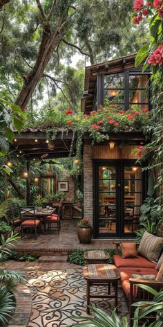 an outdoor patio with lots of plants and furniture