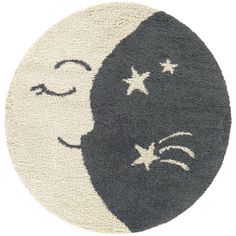 a black and white rug with an image of a crescent moon on it's side