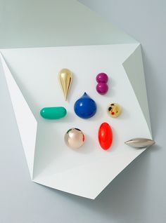 several different colored objects are placed on a piece of paper