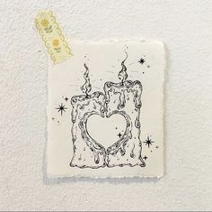 a piece of paper with a drawing of a heart shaped candle and stars on it