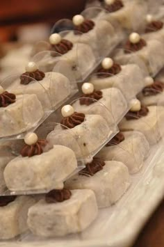 small desserts are arranged in plastic containers on a table