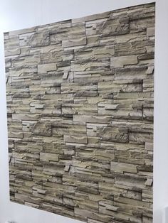 a wall made out of stone tiles in a bathroom