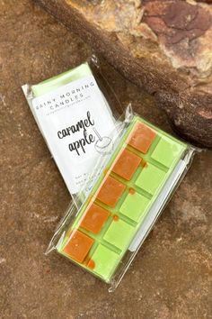 an orange and green candy bar sitting on top of a rock