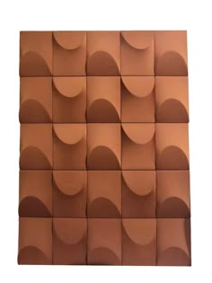 a wall made out of brown tiles with wavy shapes on the top and bottom half