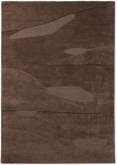 a brown rug with an abstract design on it