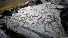 an old rock with some animals on it