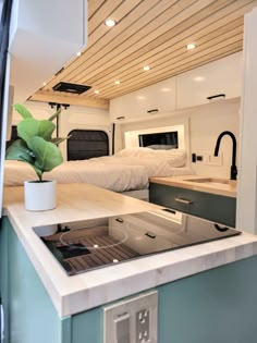 the interior of a camper with two beds and a kitchen