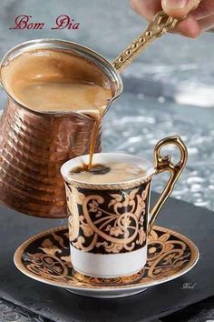 a person pouring coffee into a cup on top of a saucer with a spoon