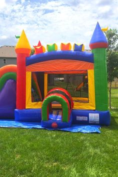 an inflatable bouncy castle with slide on the lawn