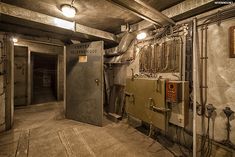 the inside of an industrial building with pipes and electrical equipment