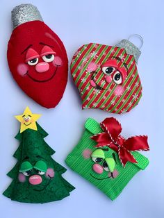 three christmas ornaments are shown on a white surface, one is red and the other is green