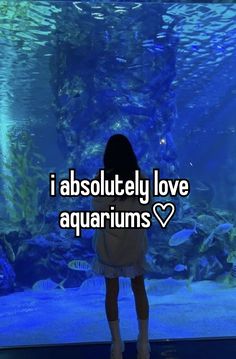 a girl standing in front of an aquarium with the words i absolutely love aquariums