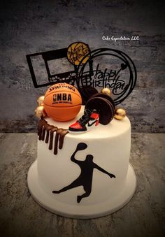 a birthday cake decorated with basketballs and other sports related items on top of it