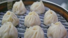 some dumplings are being cooked in a frying pan