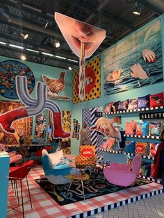 a room filled with lots of colorful furniture and art on the walls next to a checkered floor