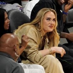 a woman sitting next to a man at a basketball game